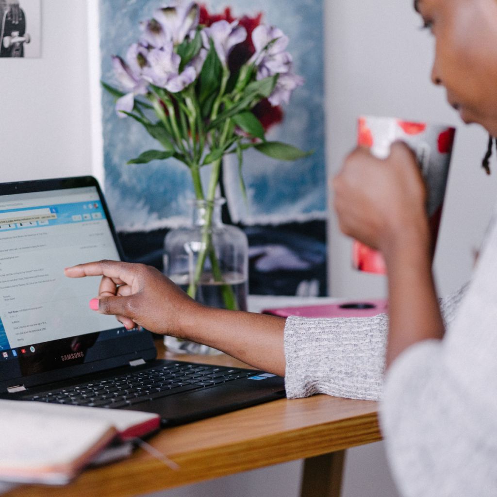 woman at home sipping coffee and sorting emails