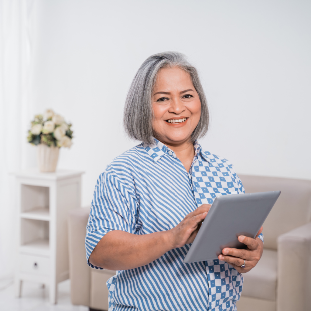 women holding a tablet and standing inside her home