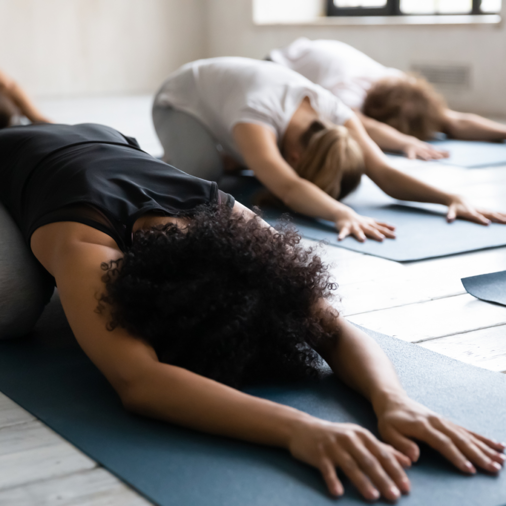 women on mats doing yoga